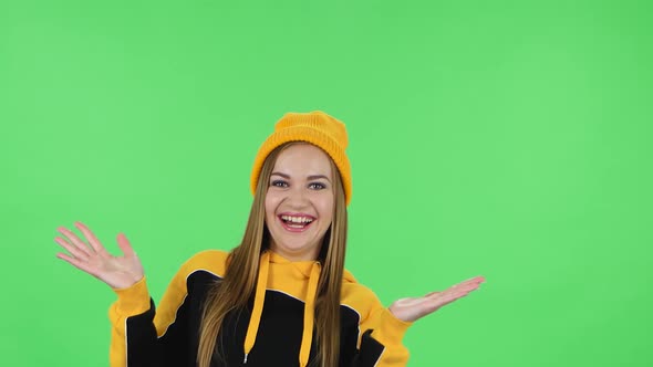 Portrait of Modern Girl in Yellow Hat Is Laughing . Green Screen