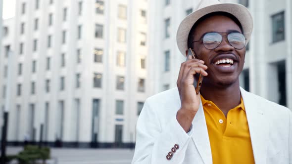 African American businessman in white suit and fedora hat