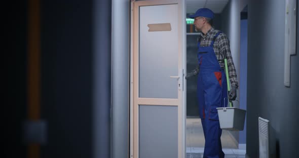 Janitor Cleaning a Corridor