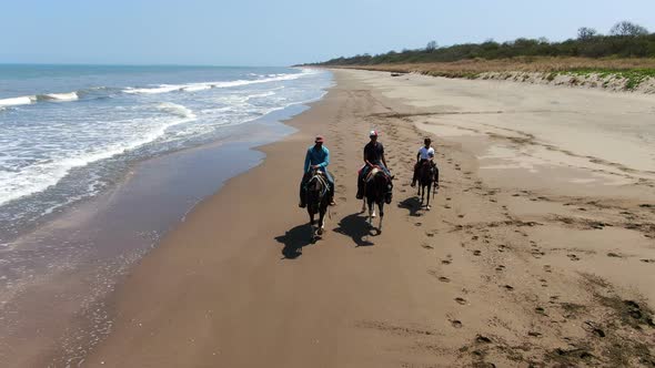 Family Riding Horses on the Seashore