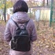 A Brunette with Short Hair in a Brown Jacket Walks in the Park on a Sunny Autumn Day - VideoHive Item for Sale