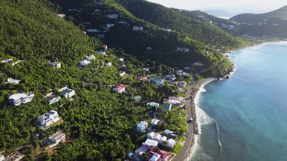 Aerial drone rotation shot over local homes on the beach on British Virgin Island Tortola.