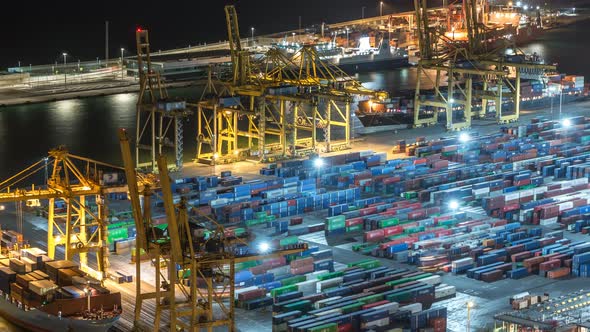 Seaport and Loading Docks at the Port with Cranes and Multicolored Cargo Containers Night Timelapse