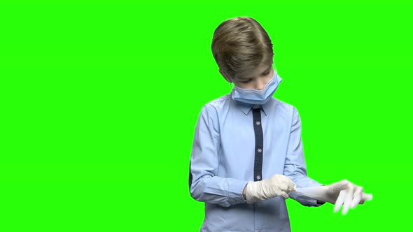 Child Little Boy Puts on Medical Gloves