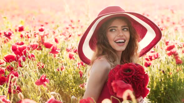 Outdoor Portrait of a Beautiful Girl. Young Beautiful Woman Walking Through a Poppy Field in Summer