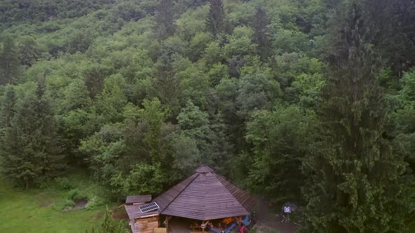 Aerial view of a wooden open hut with people enjoying the evening.