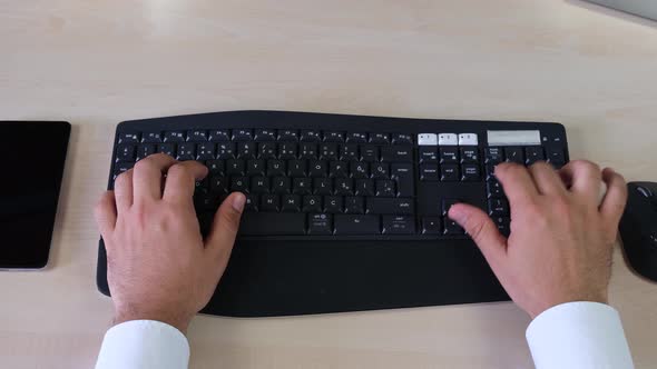 Top Shot Of Man's Hands Typing On Keyboard