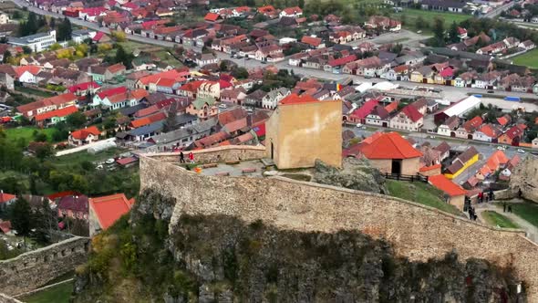 Aerial drone view of Rupea Fortress, Romania. Citadel located on a cliff, tourists, town