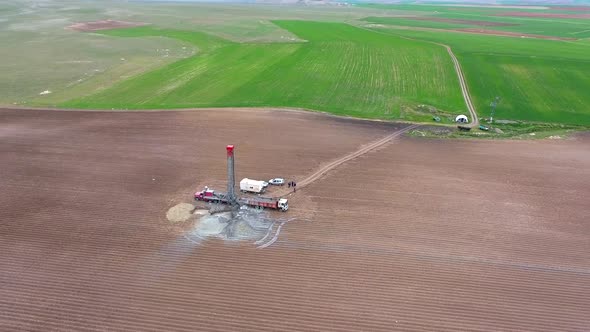 Drilling Rig Work on Flat Agricultural Brown Field