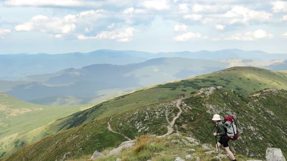 Woman wanderer on the top Shpitsy mountain in Carpathians. Travel sport lifestyle concept