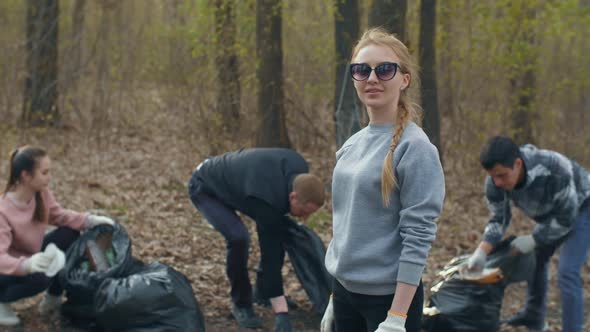 Volunteers Collecting Garbage in the Forest