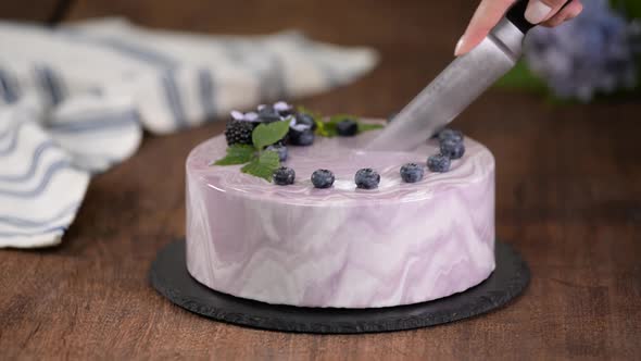 Cutting Berry Mousse Cake With Mirror Glaze.