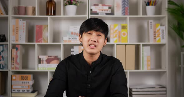 Angry boss sitting at workplace desk look at camera