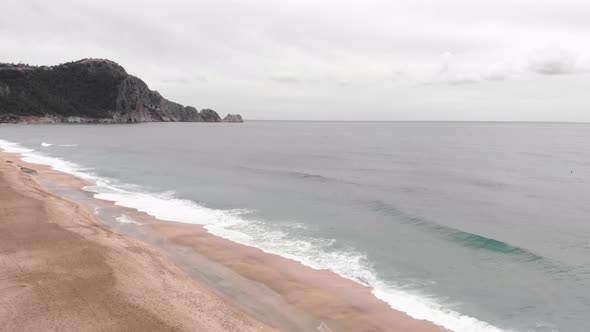 Ocean waves break on sand beach