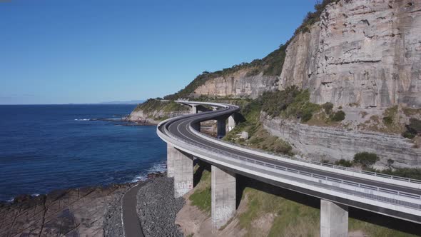 close approaching aerial view of sea cliff bridge