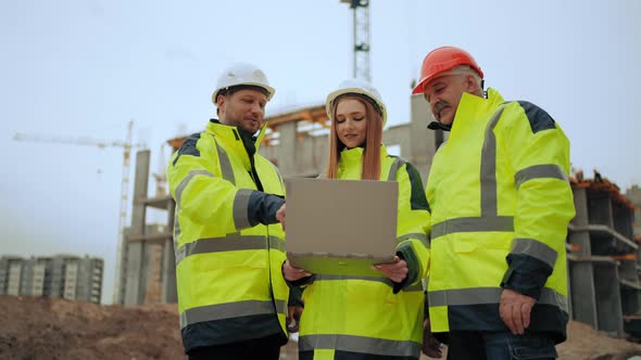 Engineers and Foreman are Discussing Project in Building Site Professional Male Builders