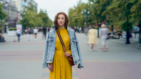 Time Lapse of Pretty Female Student Standing Outside in Pedestrian Street While Men and Woman are