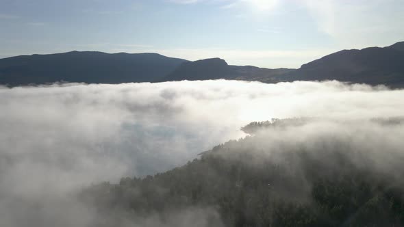 Cinematic flight above low clouds at Jotunheimen National Park, Norway