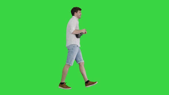 Young Man Playing a Ukulele, Singing and Walking on a Green Screen, Chroma Key