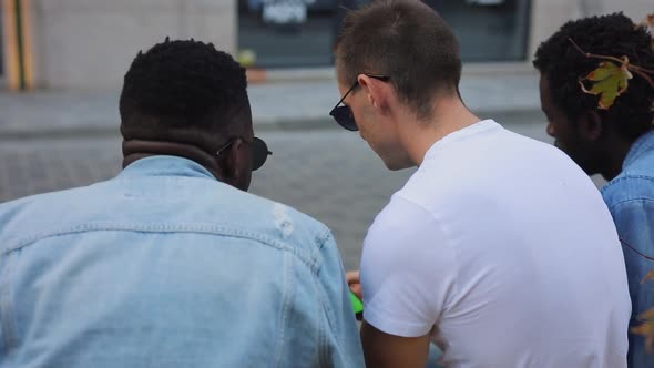 Multiracial Group of Friends Chatting and Looking at the Phone