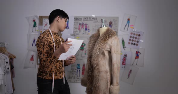 Professional fashion designer man looking mannequin model