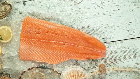 Super Slow Motion Shot of Falling Big Fresh Salmon Steak Into Crushed Ice at 1000 Fps.