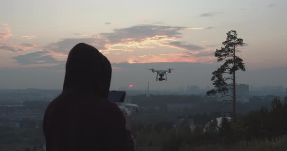 Silhouette Man Launching Quadcopter Into Sky