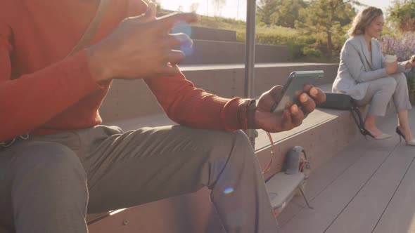 Black Man Watching Music Video on Smartphone Outdoors