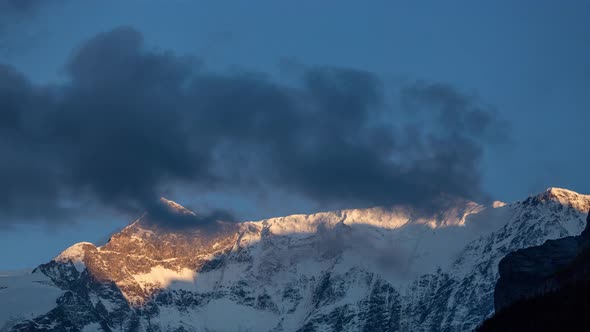 Timelapse day to dusk Fiescherluecke above Grindelwald, dancing clouds