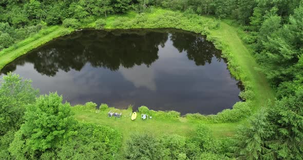 An aerial drone look down shot of a small fishing pond in the Catskill mountains.