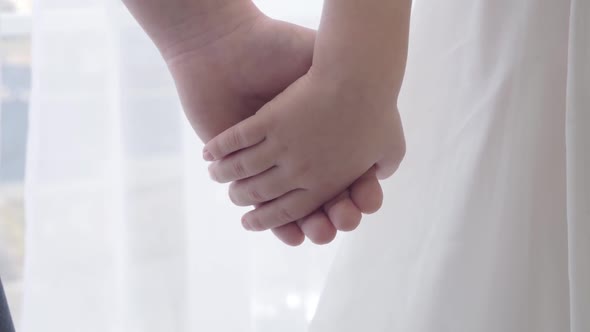 Close-up of Little Caucasian Children's Hands Holding Each Other. Togetherness, First Love, Bonding
