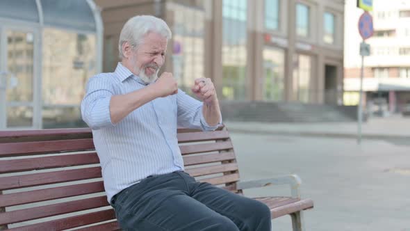 Tense Old Man Feeling Frustrated While Sitting Outdoor on Bench