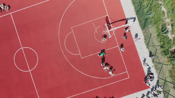 A Topdown Aerial View of Teenagers Playing Basketball on the Basketball Court