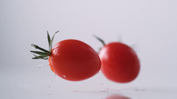 Cherry tomatos falling. Slow Motion.