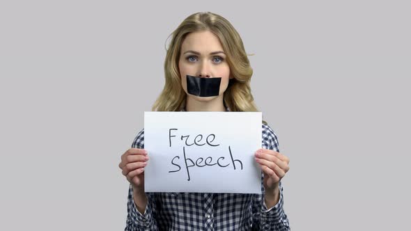 Free Speech Concept Young Woman with Taped Mouth