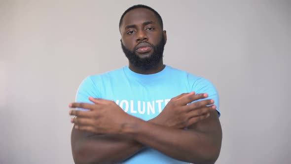 Serious Afro-American Volunteer Standing With Hands Crossed, Altruistic Activity