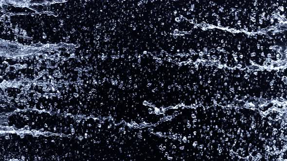 Super Slow Motion Shot of Water Side Splashes Isolated on Black Background at 1000Fps alt