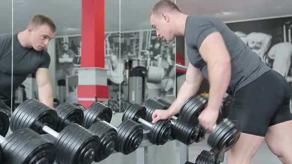 Young Man Preforming Dumbbell Lateral Raise  Exercise For Shoulders