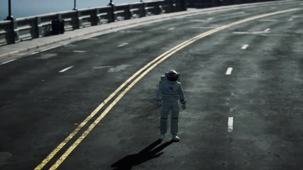 Astronaut Walks in the Middle of a Road alt