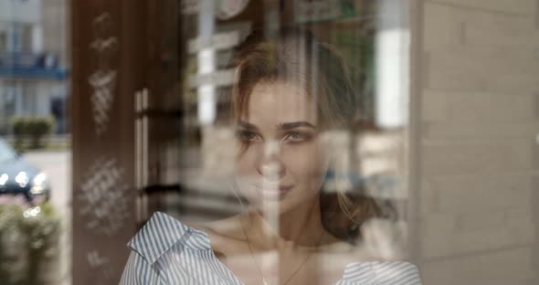 Girl Tenderly Smiling Sitting By The Window