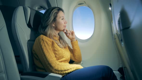 Aircraft Cabin with a Gorgeous Woman in It While Flying