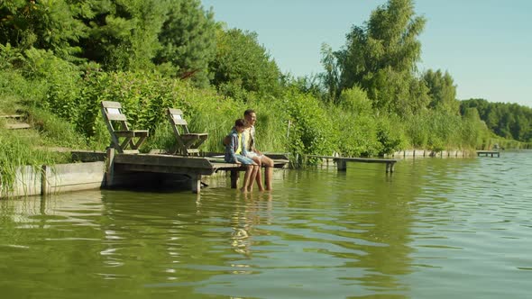 United Family Enjoying Leisure Looking at Scenic View From Jetty on Lake