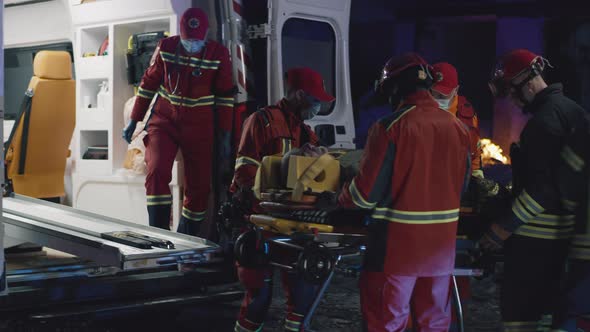 Diverse Paramedics Transporting Patient After Accident
