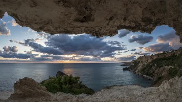 Timelapse of Beautiful Light Sunset Sky with Reflection Over Sea and Colorful Clouds Flowing in the