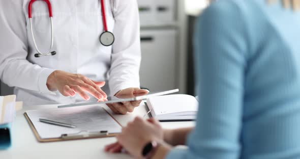 Doctor Examining Information on Digital Tablet In Front of Patient Closeup  Movie Slow Motion