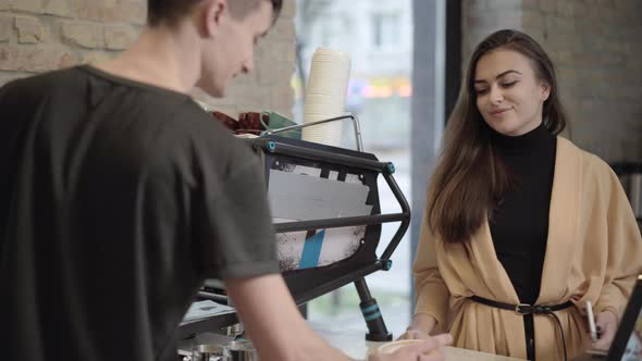 Portrait of Young Beautiful Woman Buying Coffee