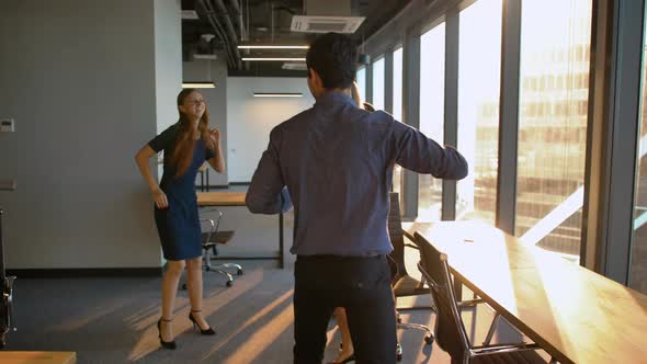 Group of Businesspeople Dancing in Office.