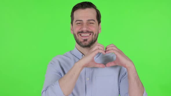 Portrait of Man Showing Heart Shape By Hands Green Screen