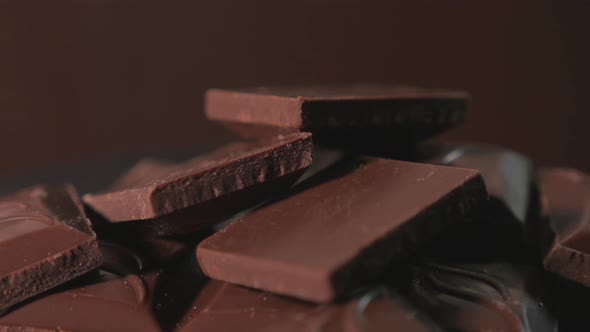 Pieces of Sweet Dark Chocolate Rotate on a Circular Rotary Display