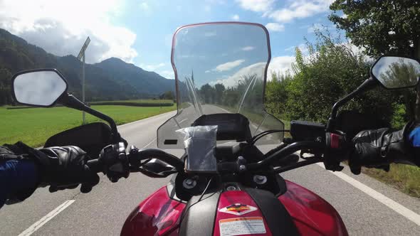POV of Biker Rides a Motorcycle on a Scenic Mountain Road in Austria